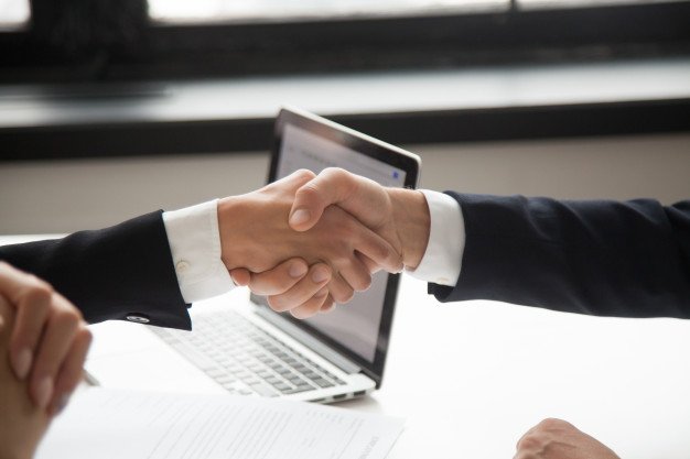 businessman-handshaking-businesswoman-showing